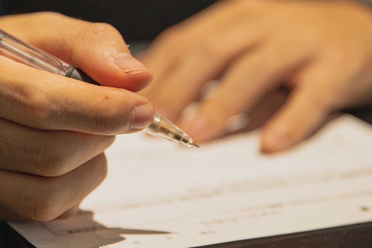 A Man Writes A Check