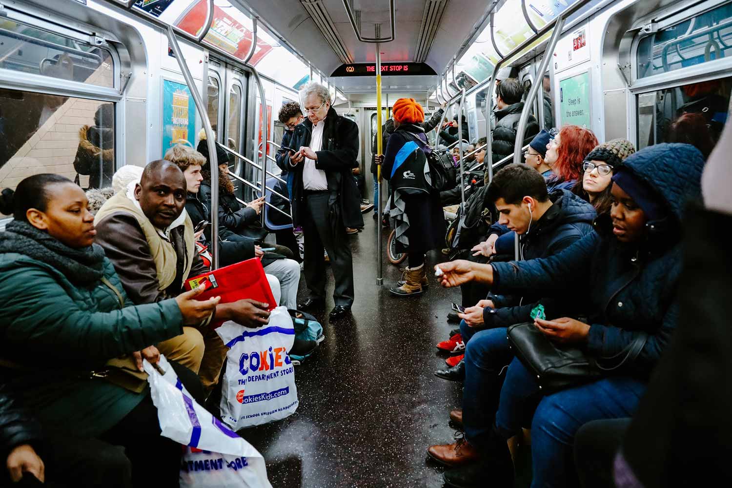 People Sitting In A NYC Subway Train