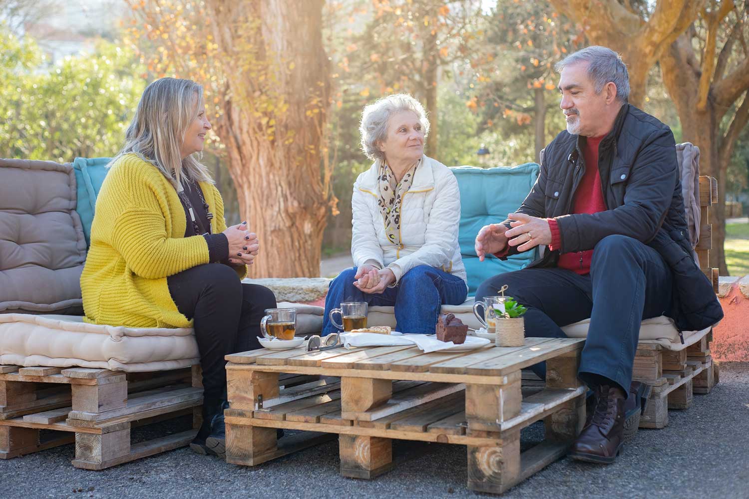 People Having Tea In A Park Cafe